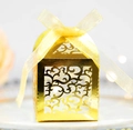 Golden laser-cut hollow candy box with ornate vine patterns and a yellow organza ribbon - Reflective Gold