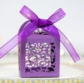 Detailed view of purple laser-cut wedding candy box with elegant ribbon bow decoration - Deep purple