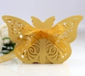 Elegant gold laser-cut butterfly candy box with a satin ribbon on a white background - Gold