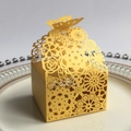 Laser-cut bright yellow butterfly candy box with floral patterns on white plate - Pearlescent Gold