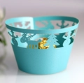 Detail of light blue laser-cut Christmas cupcake wrappers with reindeer and snowflake patterns - Tiffany Blue