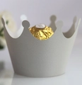 Macro detail of a grey matte crown cupcake wrapper with golden chocolate inside - Silver