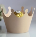 Close-up of beige crown-shaped paper chocolate holder for elegant party dessert decor - Jade Star Champagne