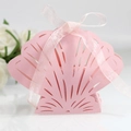 Pink seashell laser-cut candy gift box with a matching ribbon bow and intricate hollow patterns - Pink