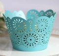 Close-up of laser-cut light blue cupcake wrapper with pearlescent finish and hollow pattern - 5*5*8CM / Tiffany Blue