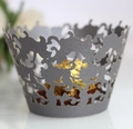 Macro detail of laser-cut pearlescent paper cupcake wrapper with floral vine patterns - Silver Charcoal