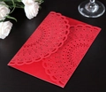 Detail of red laser-cut wedding invitation with intricate floral patterns on wood - Pearlescent Red