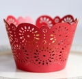 Macro detail of red laser-cut floral cupcake wrappers with pearlescent hollow design - Pearlescent Red