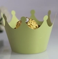Close-up of light green crown cupcake wrapper holding a single chocolate truffle - Emerald Green