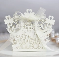 Detail of laser-cut hollow lovebird candy box with cream organza ribbon and pearls - Ivory