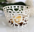 Close-up of ivory laser-cut cupcake wrapper with geometric patterns and chocolate - Ivory