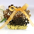 Elegant gold laser-cut wedding favor box with floral patterns and a yellow satin ribbon - Reflective Gold