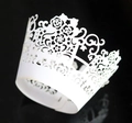 Detailed laser-cut heart and floral vine patterns on white paper cupcake wrappers - White