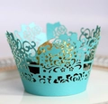 Close-up of laser-cut Tiffany blue cupcake liner with intricate rose and vine hollow patterns - Tiffany Blue