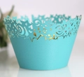Close-up of laser-cut cupcake wrappers with star pattern in bright sky blue color - Turquoise Blue