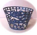 Detail of dark blue laser-cut cupcake wrappers with geometric hollow patterns - Sapphire Blue
