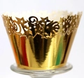 Golden laser-cut cupcake wrapper with star patterns on a transparent glass stand - Reflective Gold