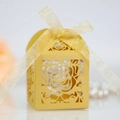 Detail of laser-cut rose pattern on gold pearlescent paper gift box with ribbon - Gold