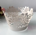 Detailed close-up of white laser-cut cupcake wrappers with floral lace patterns - Silver Grey