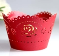 Detail view of red laser-cut cupcake wrappers featuring elegant rose hollow patterns - Pearlescent Red (5cm)