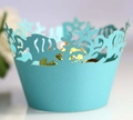 Macro shot of laser-cut ocean theme cupcake wrappers with fish and coral in cyan blue - Tiffany Blue