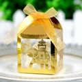 Detail of laser-cut elephant candy box with golden ribbon on a white porcelain plate - Reflective Gold