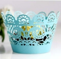 Detail of light blue laser-cut cupcake wrappers with elegant floral lace patterns - Turquoise Blue