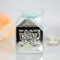 Close-up of laser-cut rose hollow favor box with elegant light blue ribbon bow detail - Reflective Silver