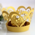 Close-up of golden laser-cut heart cupcake wrapper with Love engraving for weddings - Gold