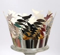 Macro shot of silver mirror laser-cut cupcake wrapper with bird and leaf lace patterns - Reflective Silver