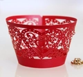 Close-up of laser-cut red cupcake wrappers with intricate heart and floral hollow patterns - Pearlescent Red