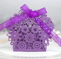 Detail of purple laser-cut gift box with floral patterns and a matching organza ribbon bow - Deep purple