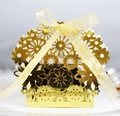 Detailed macro view of laser-cut floral patterns on a golden wedding candy gift box - Reflective Gold
