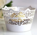 Detailed laser-cut crown pattern on white paper cupcake wrapper with hollow design - White