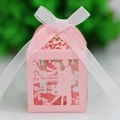 Detail of pink laser-cut wedding favor box with Love silhouette and white ribbon bow - Pink