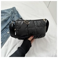 Close-up of black quilted puffer bag with glossy finish and gold zipper details - Black