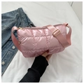 Detail of pink quilted puffer crossbody bag featuring glossy nylon fabric and metallic zipper - Pink