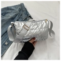 Close-up of silver quilted down fabric crossbody bag with wide strap and metallic finish - Silver