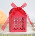 Close-up of red laser-cut wedding favor box with geometric patterns and red organza ribbon - Pearlescent Red