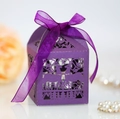 Detailed macro view of a purple laser-cut gift box with forest deer patterns and silk ribbon - Dark Purple