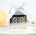 Close-up of silver laser-cut wedding favor box with light blue ribbon and pearl background - Reflective Silver