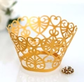 Detailed laser-cut heart pattern on gold pearlescent paper cupcake wrapper for weddings - Gold