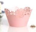 Pink laser-cut Christmas cupcake wrappers with delicate snowflake patterns for party decor - Pink