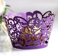 Macro view of laser-cut floral pattern on deep purple paper cupcake wrappers - Dark Purple