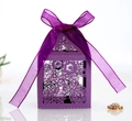 Detail of purple laser-cut wedding candy box with elegant floral hollow pattern and ribbon bow - Dark Purple