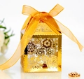 Detail of laser-cut floral pattern on golden wedding favor box with a satin ribbon - Reflective Gold