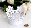 White laser-cut crown muffin cup wrap with intricate floral patterns for wedding decor - White