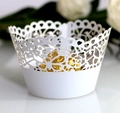 Close-up of laser-cut white lace cake wrappers with elegant heart and floral patterns - 5*5*8CM / White