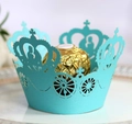 Close-up of laser-cut lake blue pumpkin carriage cake wrapper with gold chocolate - Tiffany Blue