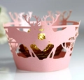 Macro view of pink laser-cut reindeer and forest cupcake wrapper with pearly finish - Pink